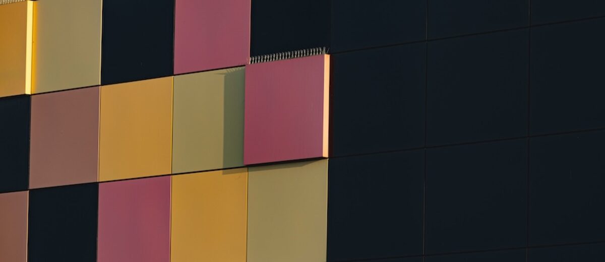 An architectural facade of colored panels arranged across a dark grid, representing many providers routed through one structured surface